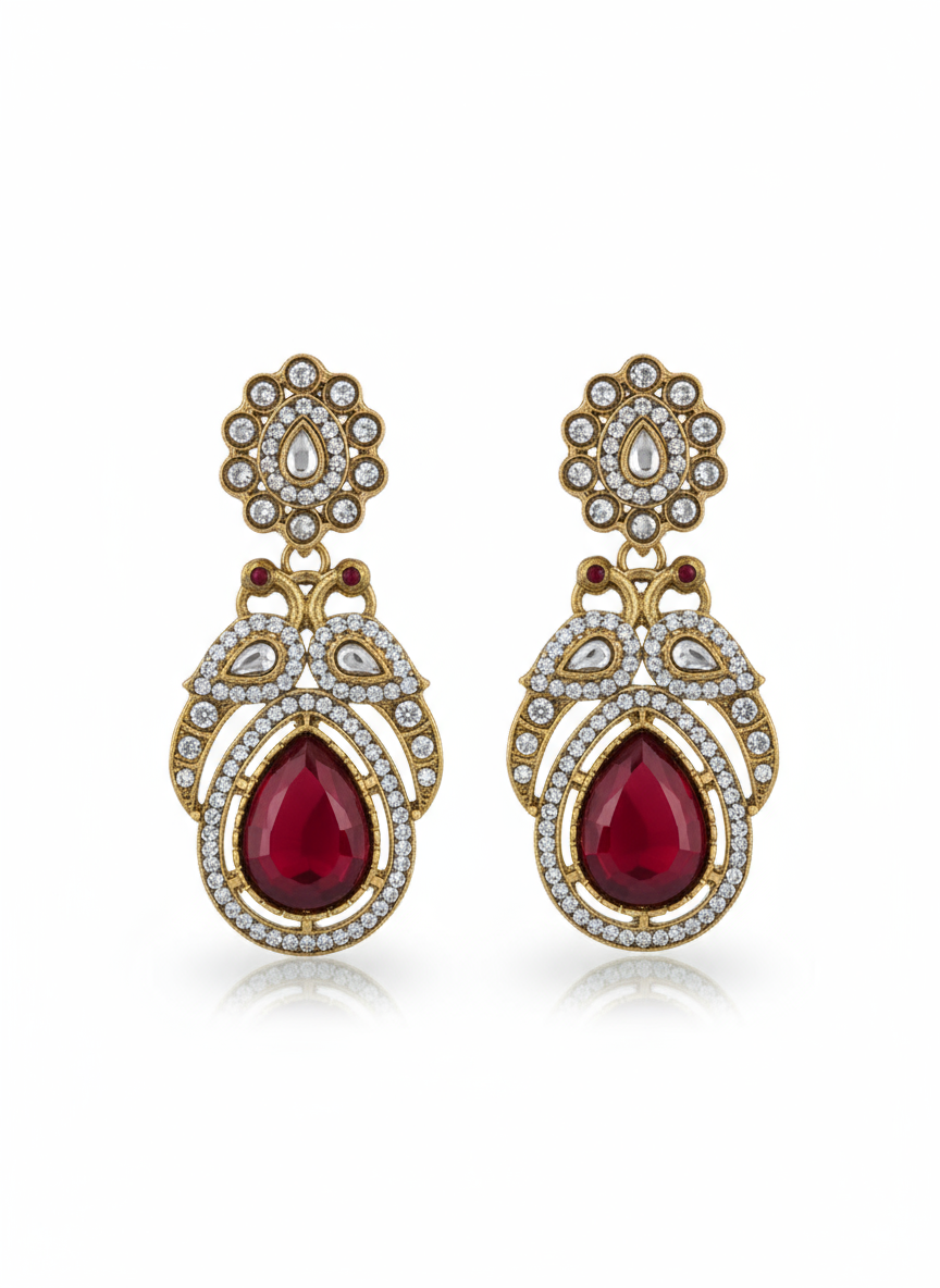 Ornate earrings with red teardrop stones and gold toned accents