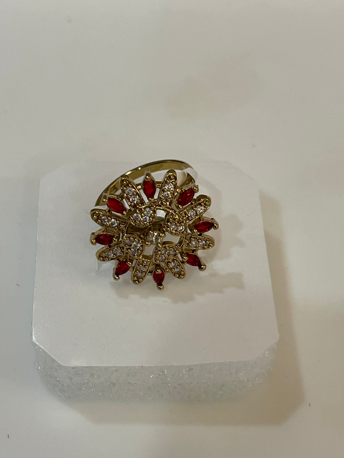 Golden ring with red gemstones.