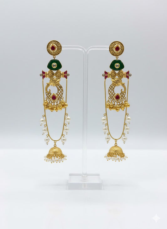 Gold toned earrings with green and red stones
