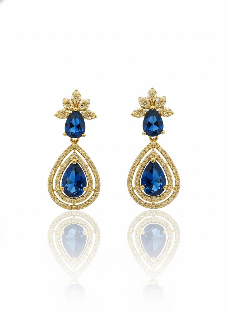 Gold finish earring with blue gemstones.