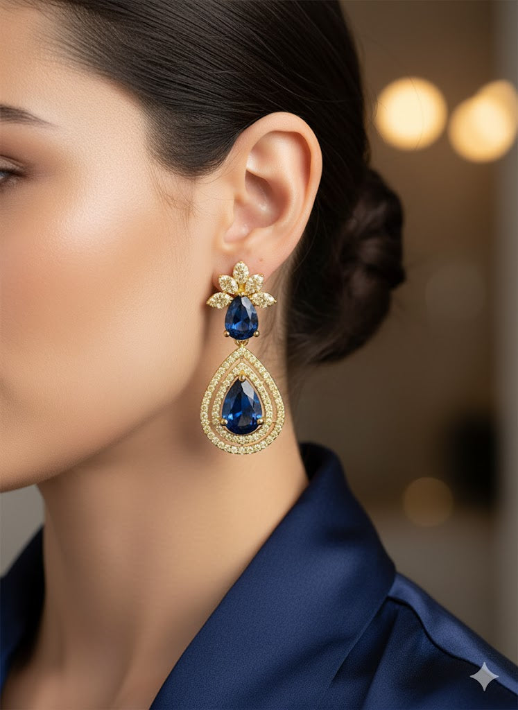 Gold finish earring with blue gemstones.