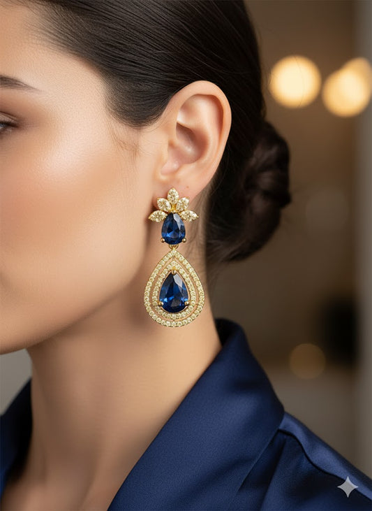 Gold finish earring with blue gemstones.