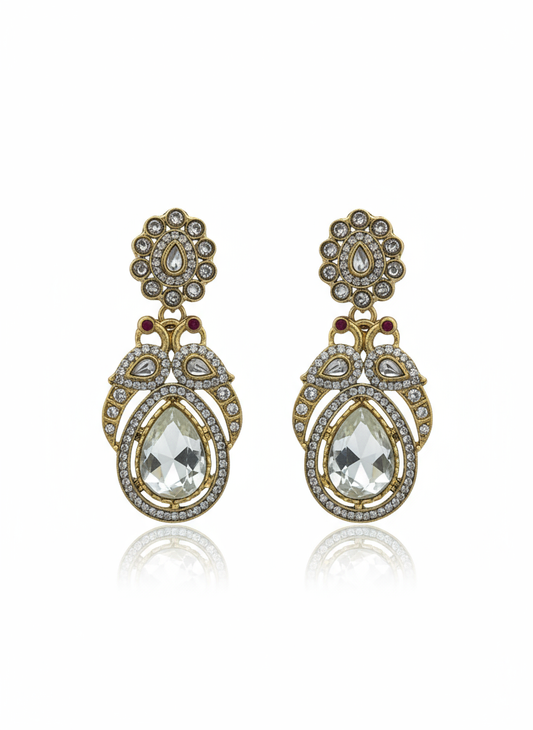 Ornate earrings with clear teardrop stones and gold toned accents