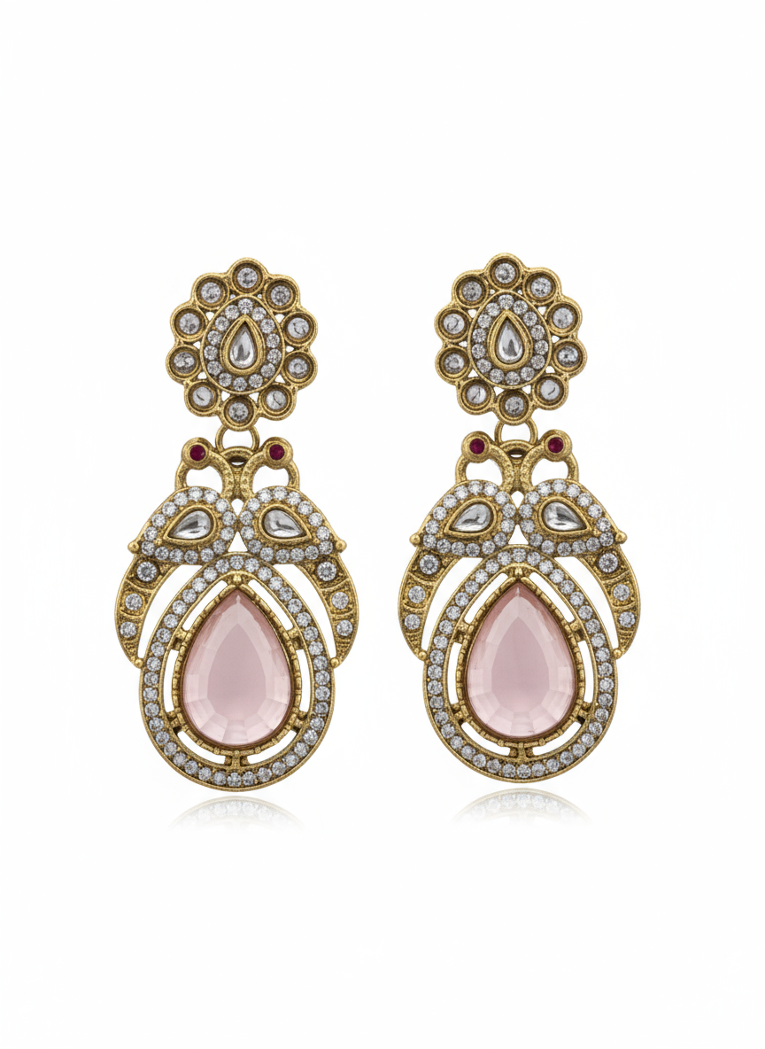 Ornate earrings with pink teardrop stones and gold toned accents