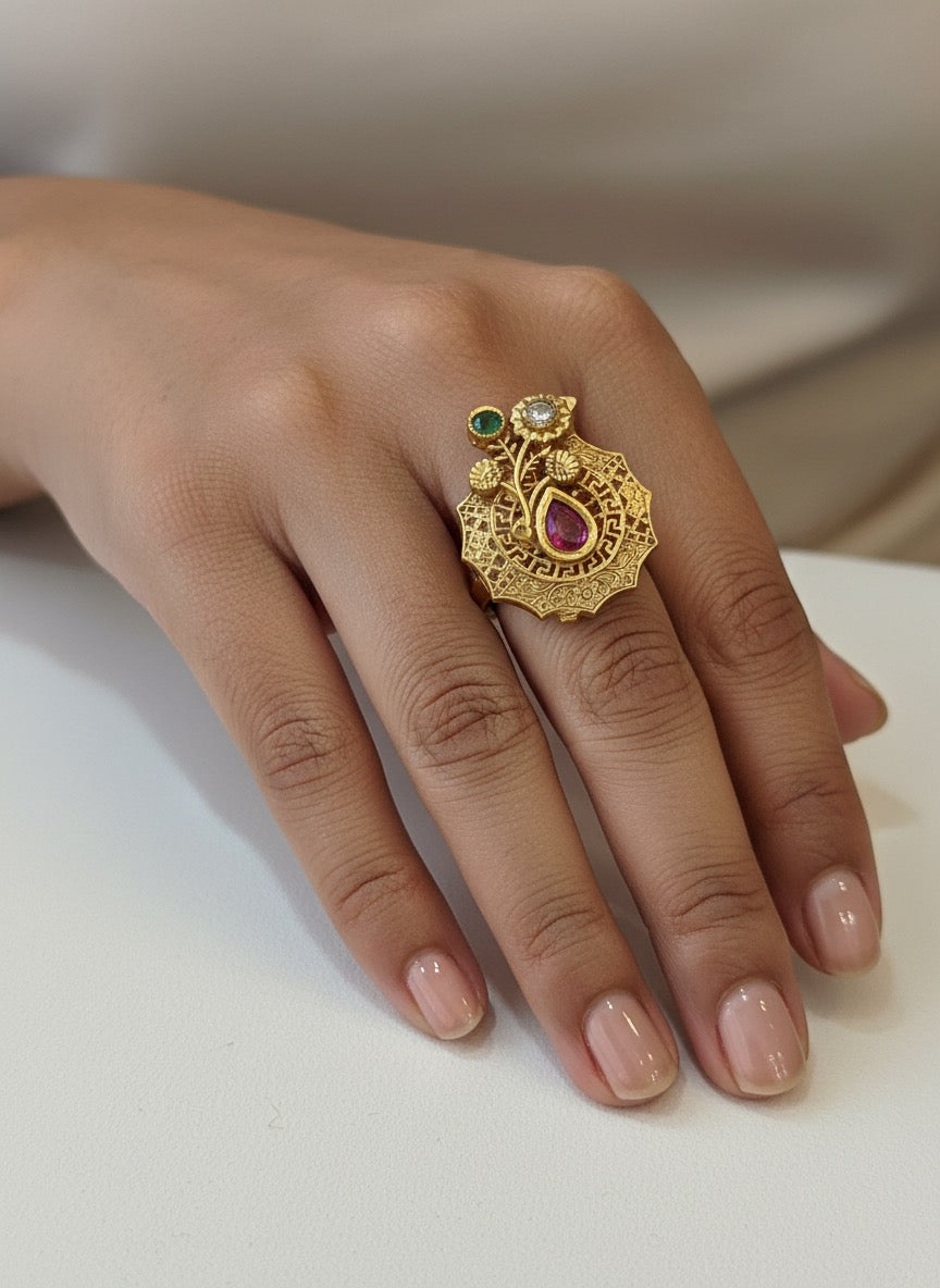 Golden ring with red white and green gemstones in petal shape