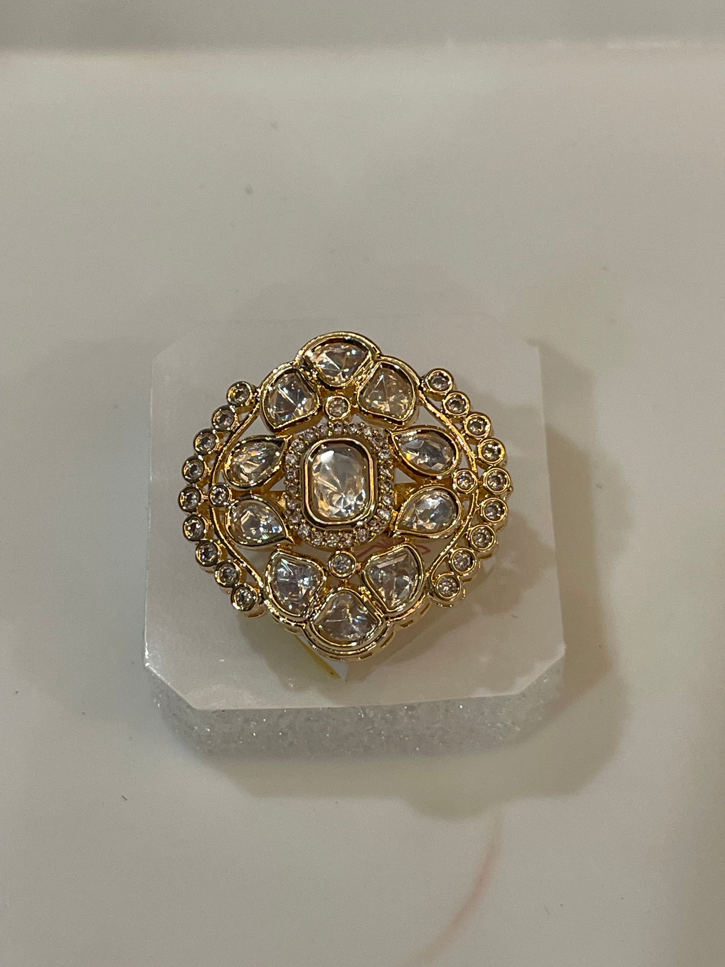 Golden ring studded with clear stones.