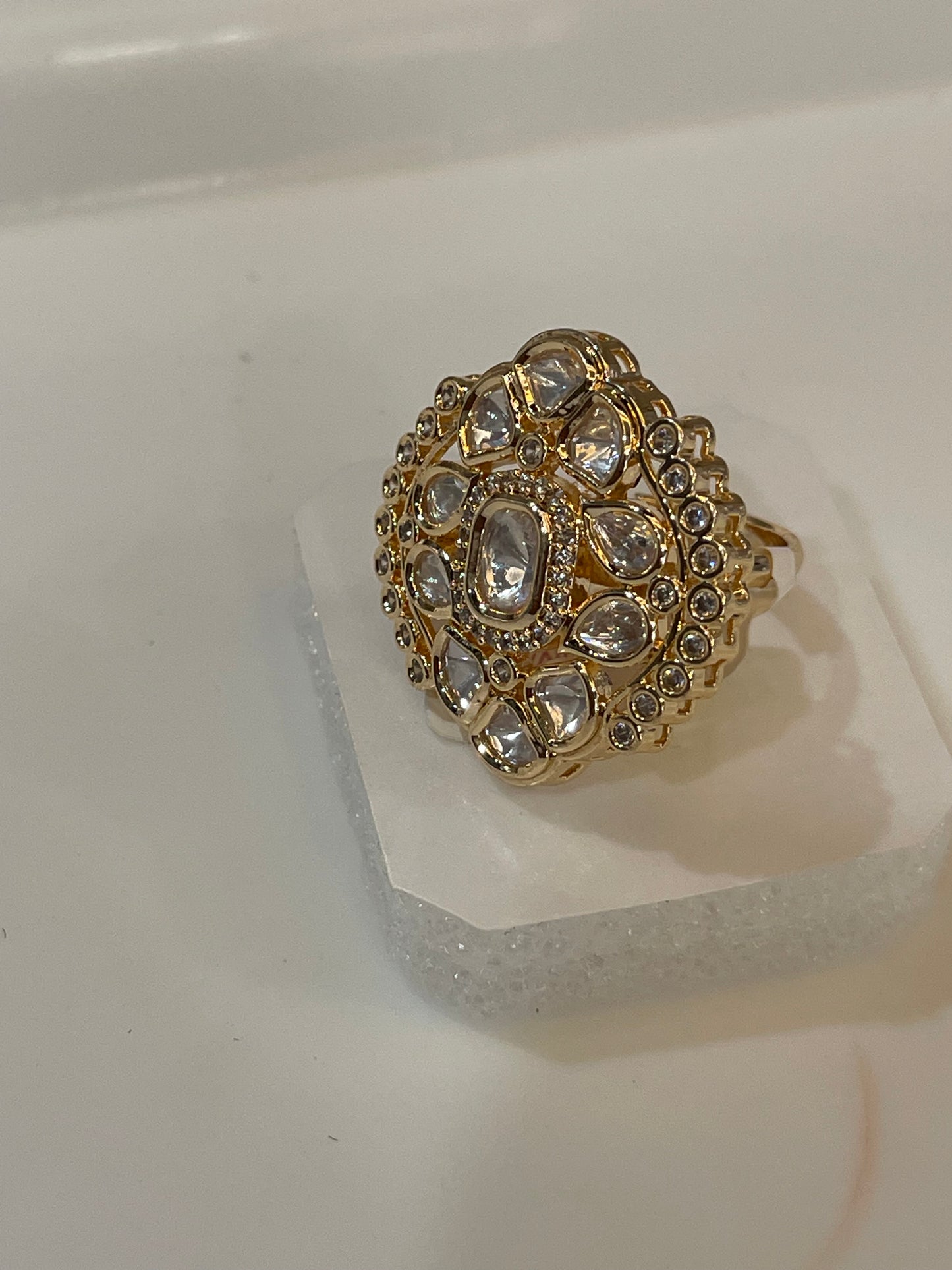Golden ring studded with clear stones.