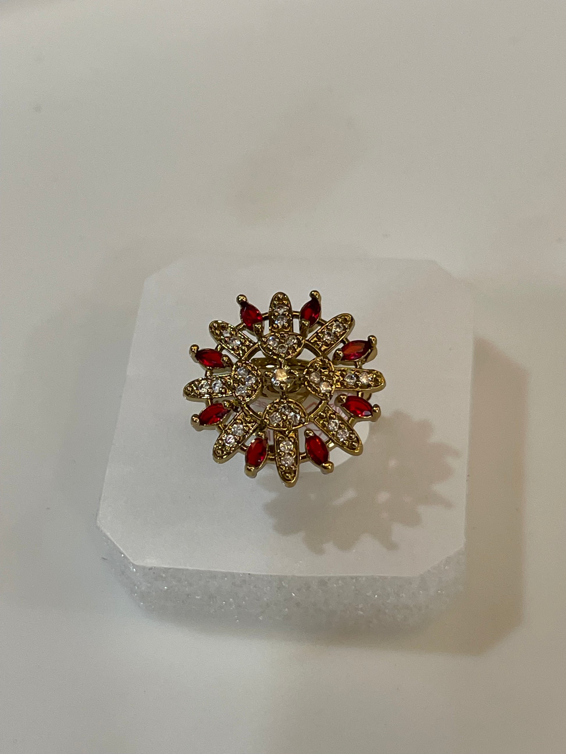 Golden ring with red gemstones.