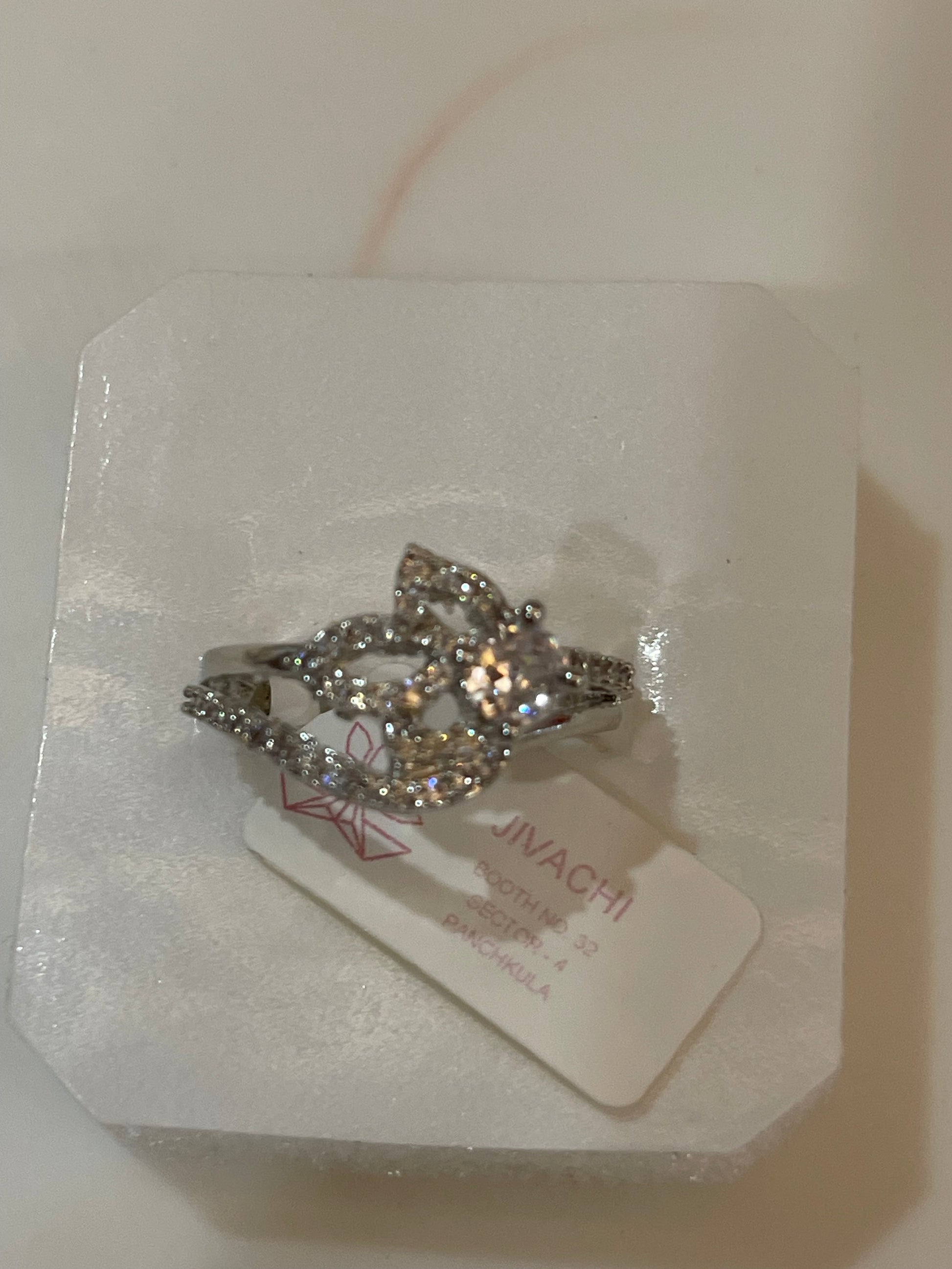 Silver plated ring with Cut Zirconia Clear Gemstone, intricate design.