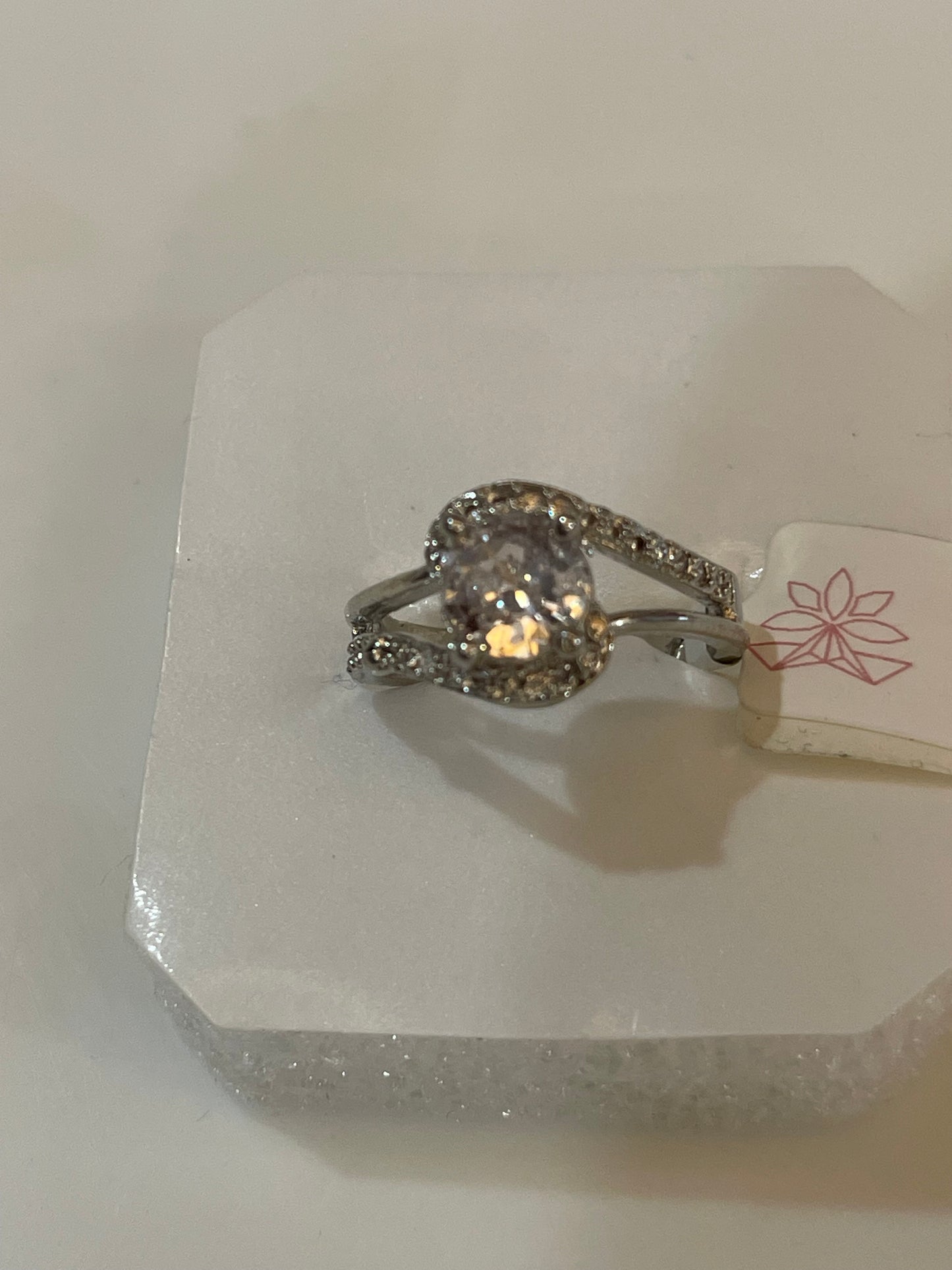 Silver plated with cut Zirconia clear gemstone.