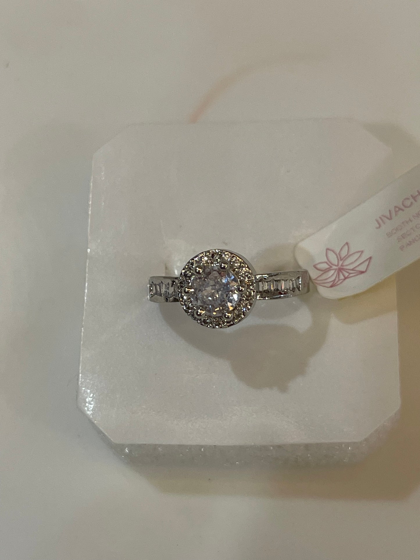 Silver plated ring with a Zirconia round clear gemstone.