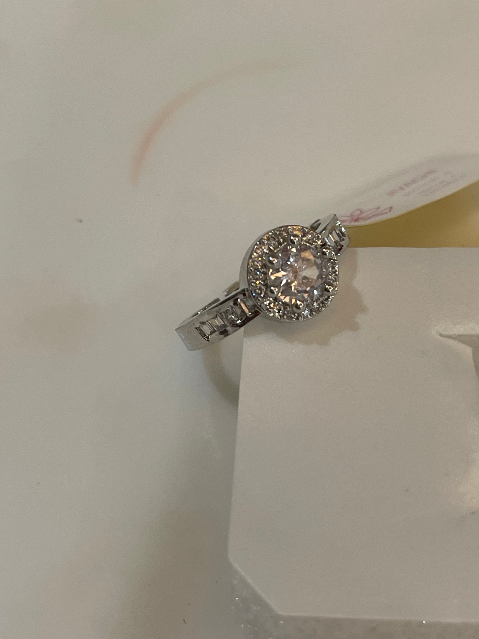 Silver plated ring with a Zirconia round clear gemstone.