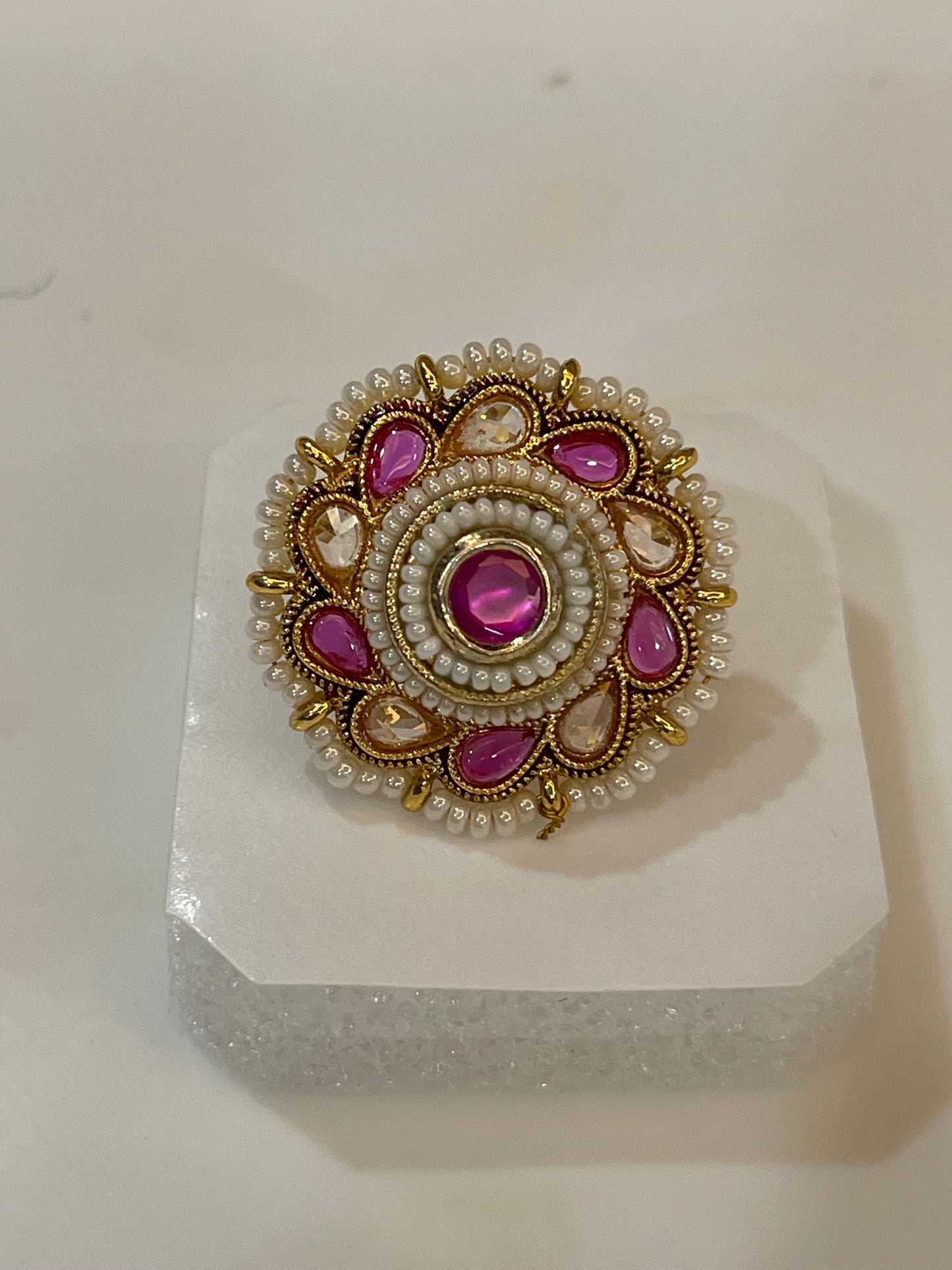 Polki ring with pink and yellow  gemstones surrounded by pearls and gold accents
