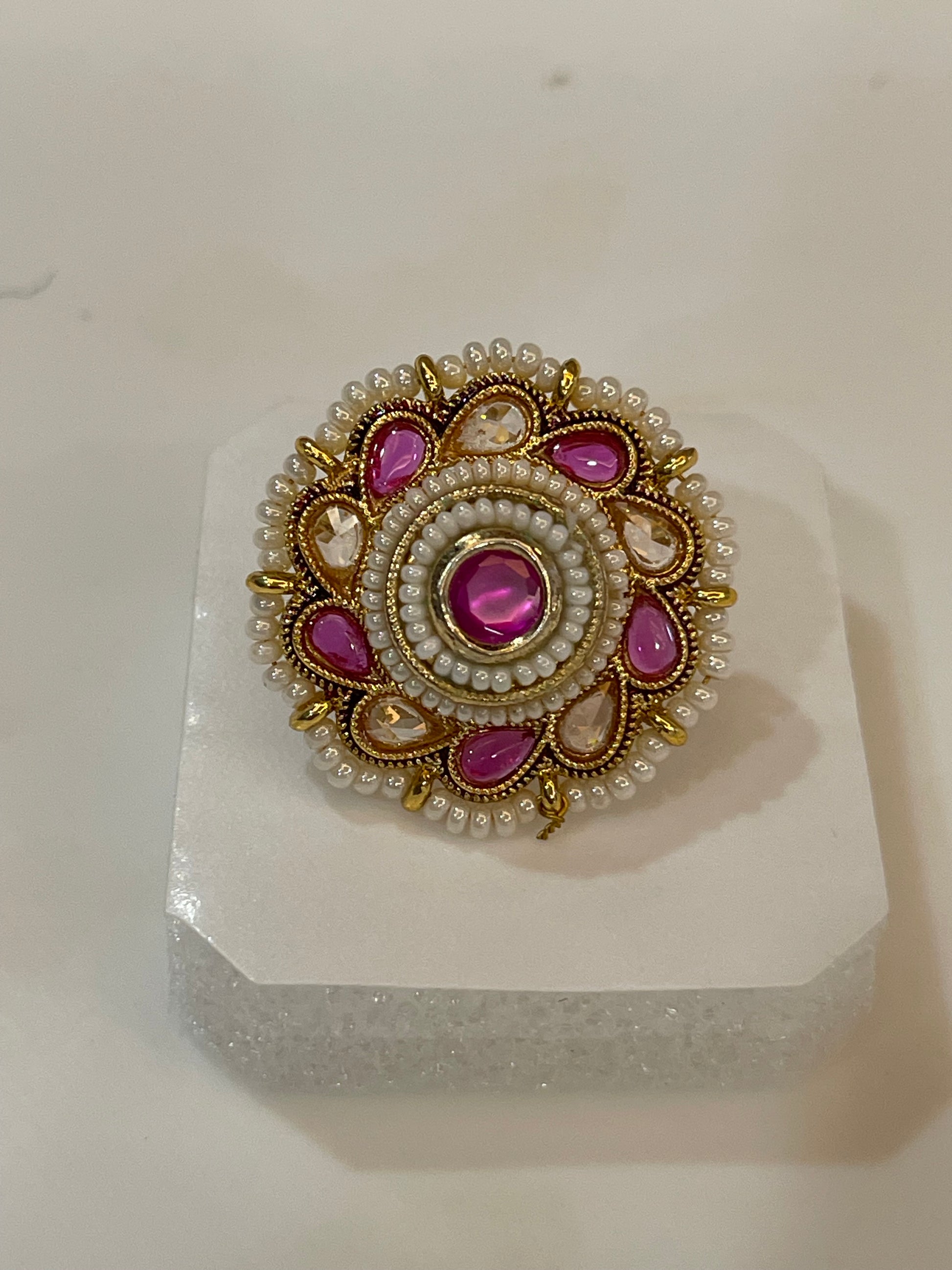 Polki ring with pink and yellow  gemstones surrounded by pearls and gold accents
