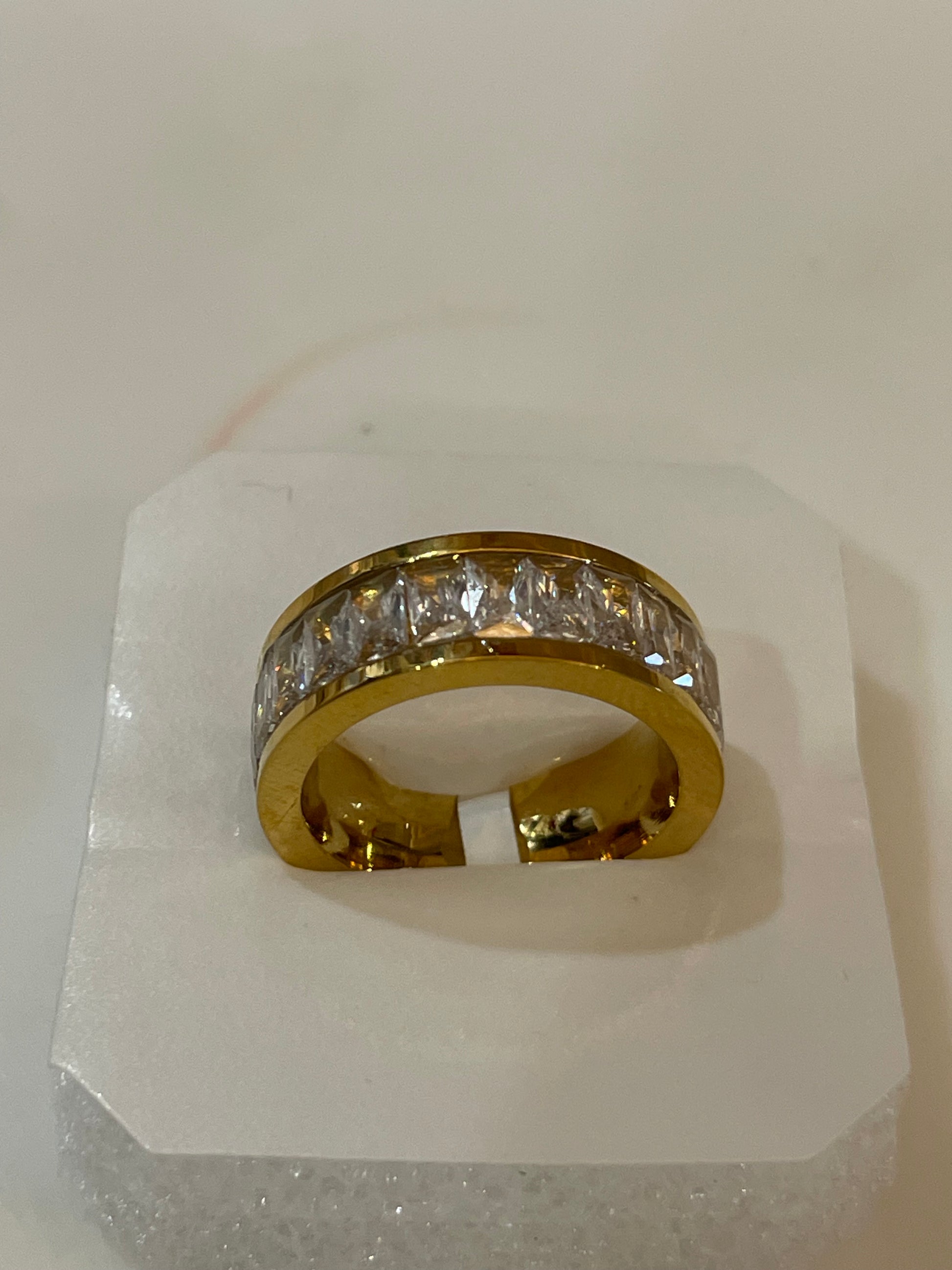 Gold plated eternity ring studded with cubic zirconia stones.