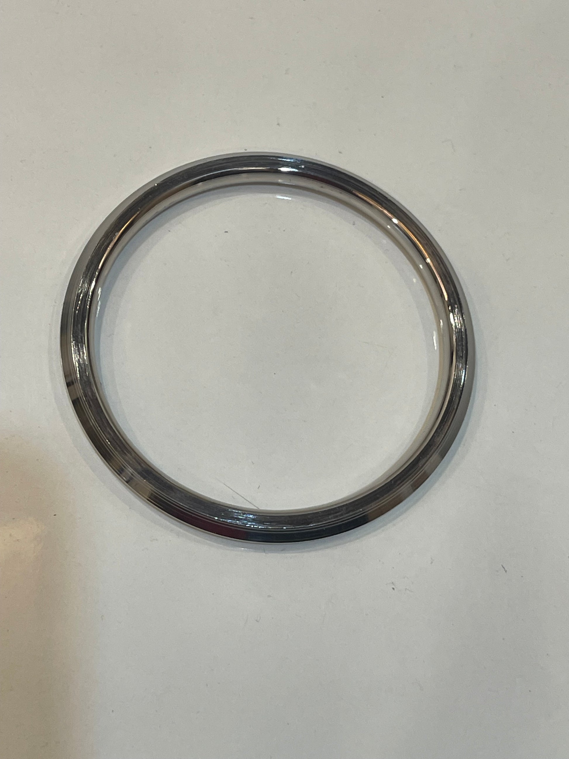 Chrome circular metal ring on a white background